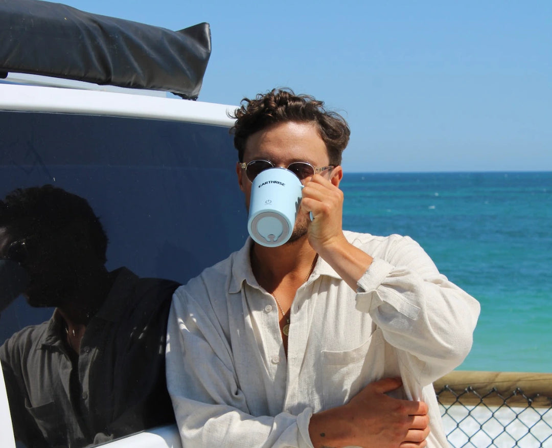 A person drinking from a mug of Earthrise coffee alternative