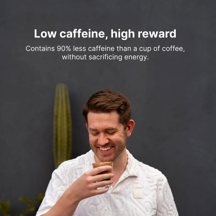 A man holding a cup of Earthrise, smiling, with the text "Low caffeine, High reward"