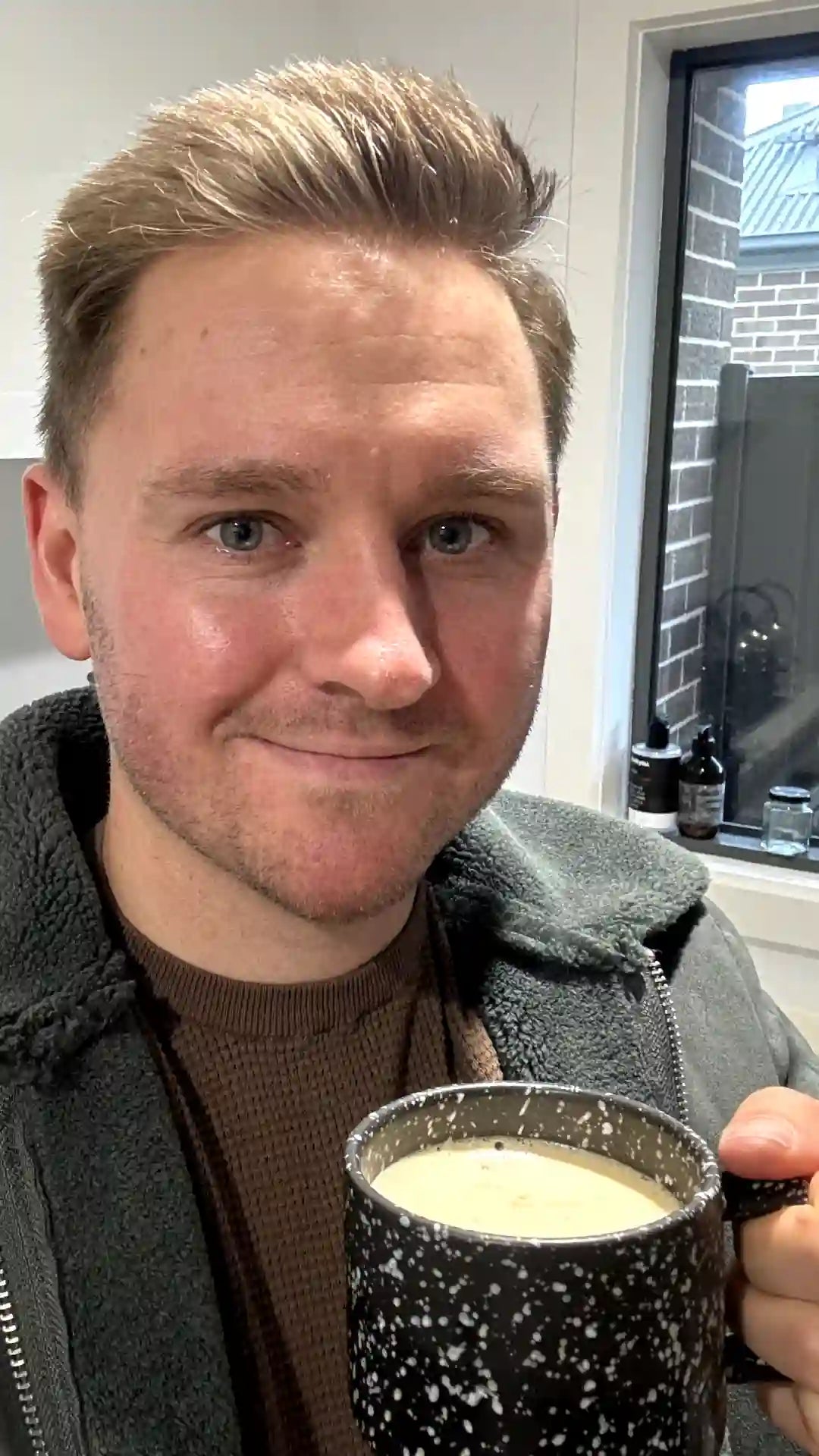 A person holding a mug of Earthrise coffee alternative