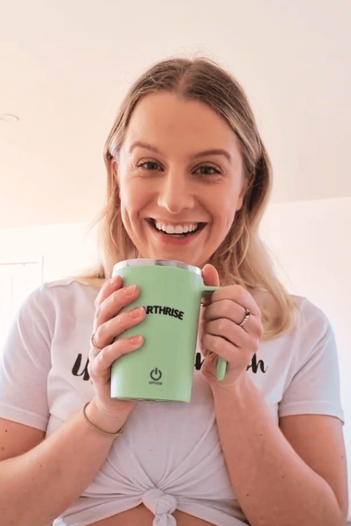 Earthrise customer smiling and holding an Earthrise mug